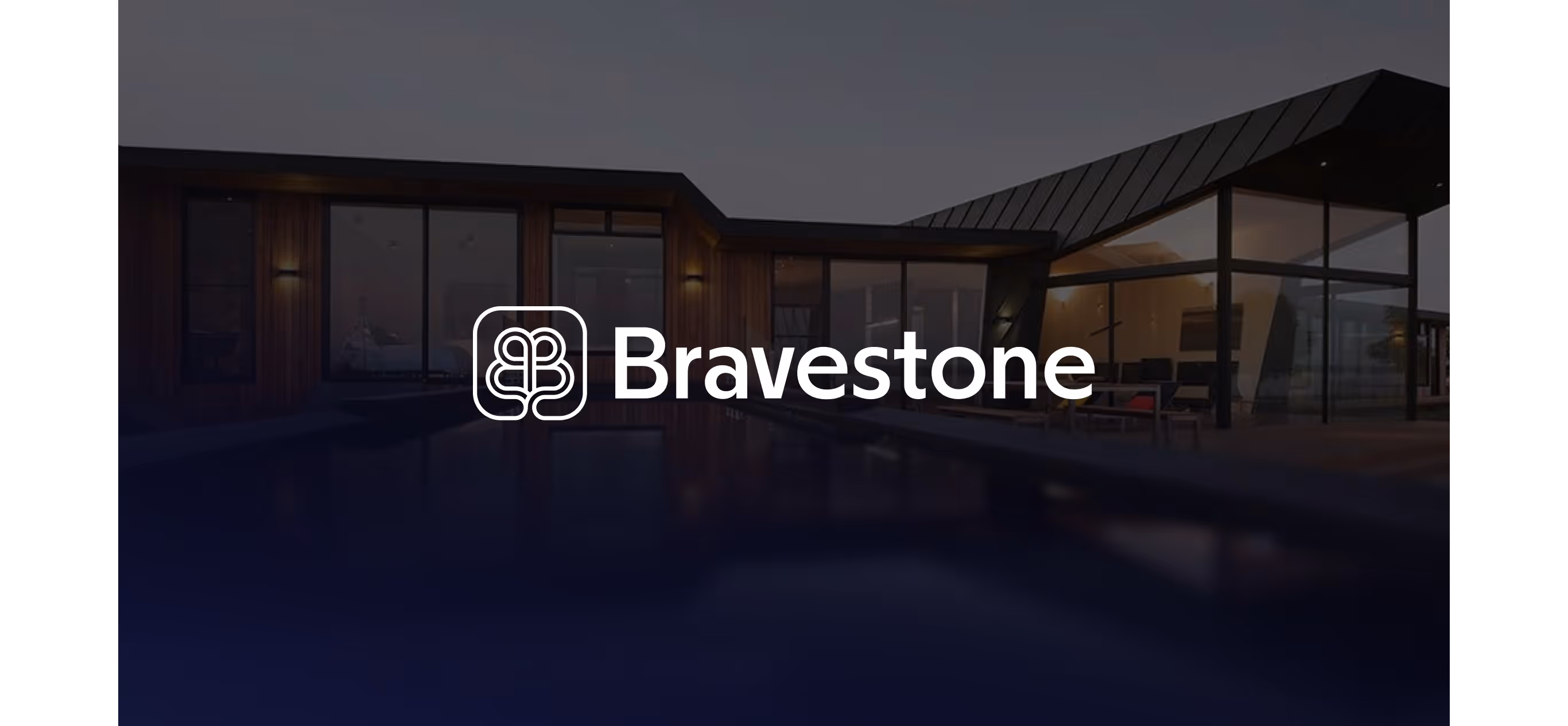 Bravestone logo over a villa at dusk