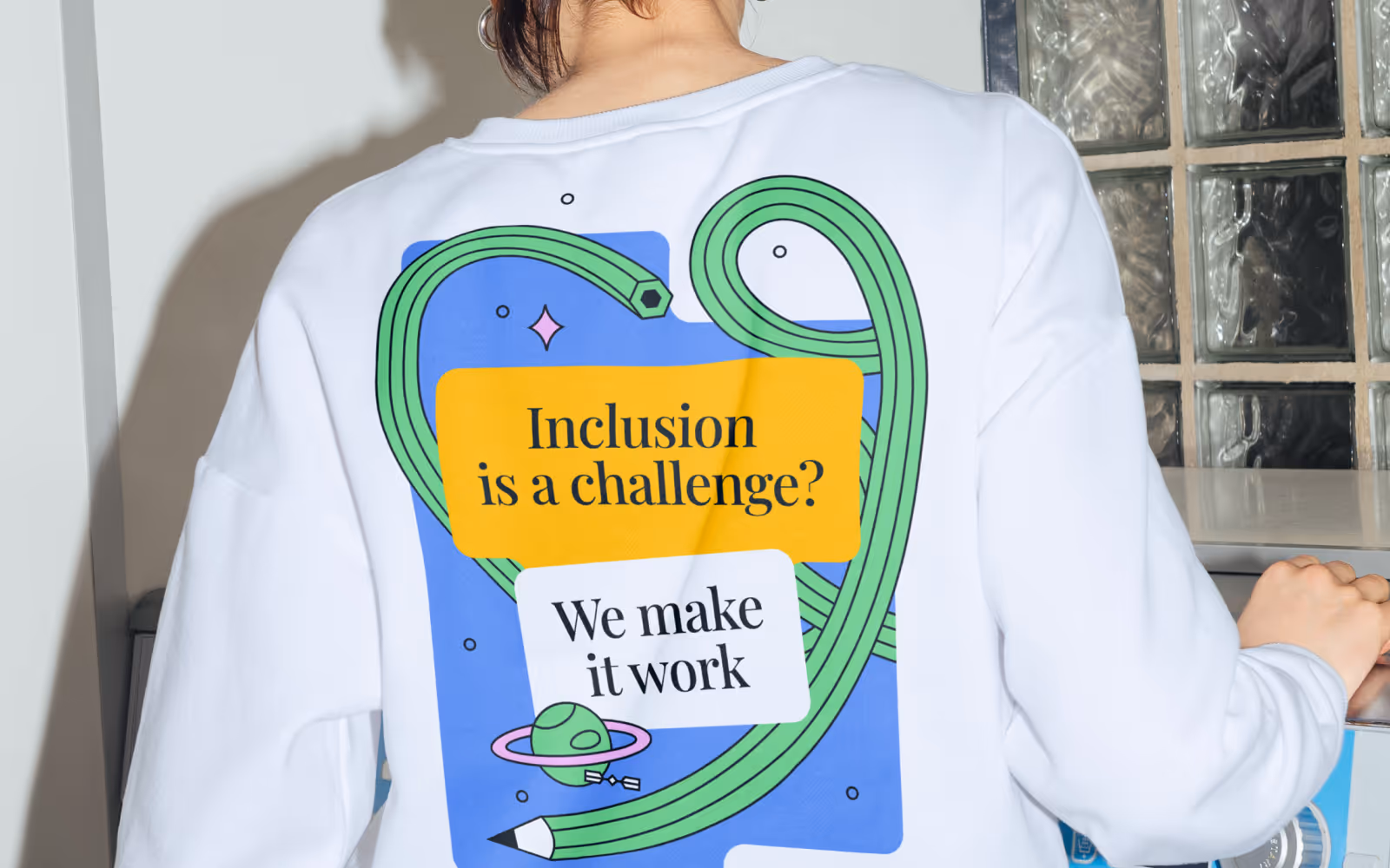 UNOWA sweatshirt with the 'Inclusion is a challenge?' illustration