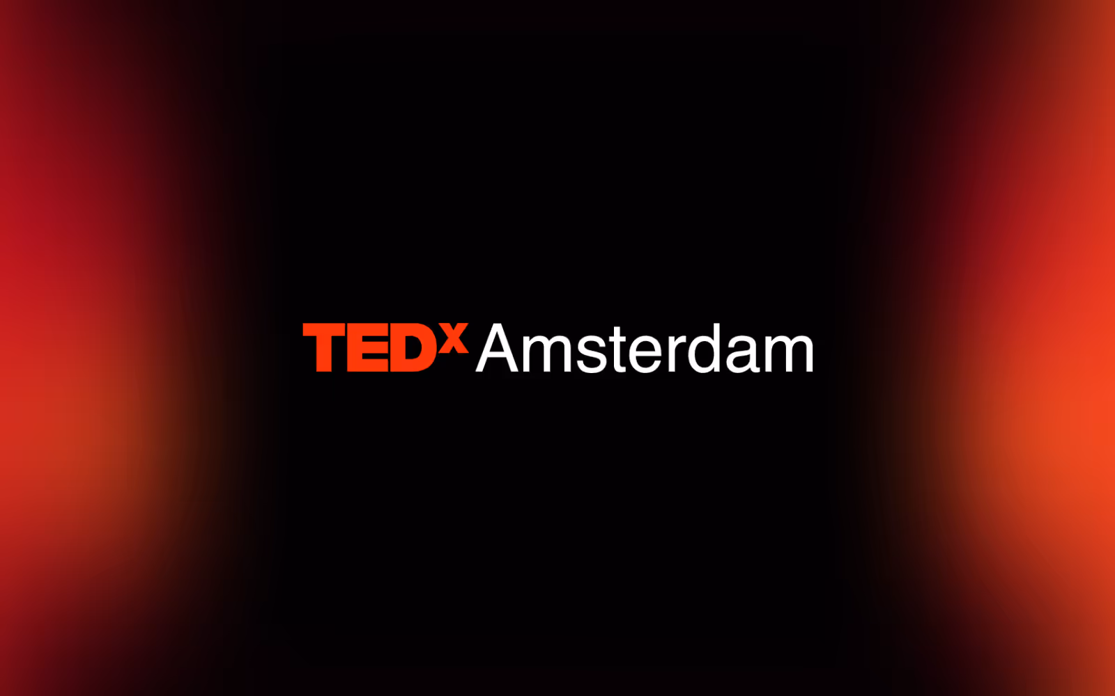 TEDxAmsterdam wordmark on a dark red background