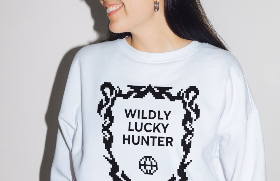 Woman in a white Lucky Hunter sweatshirt