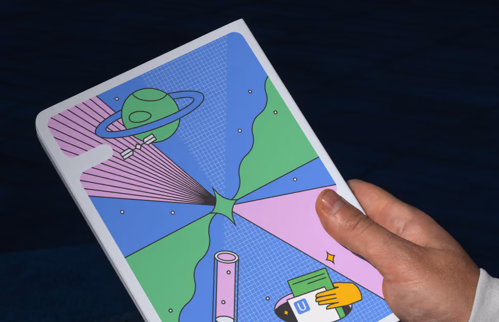 Hand holding a tablet with a colourful abstract illustration